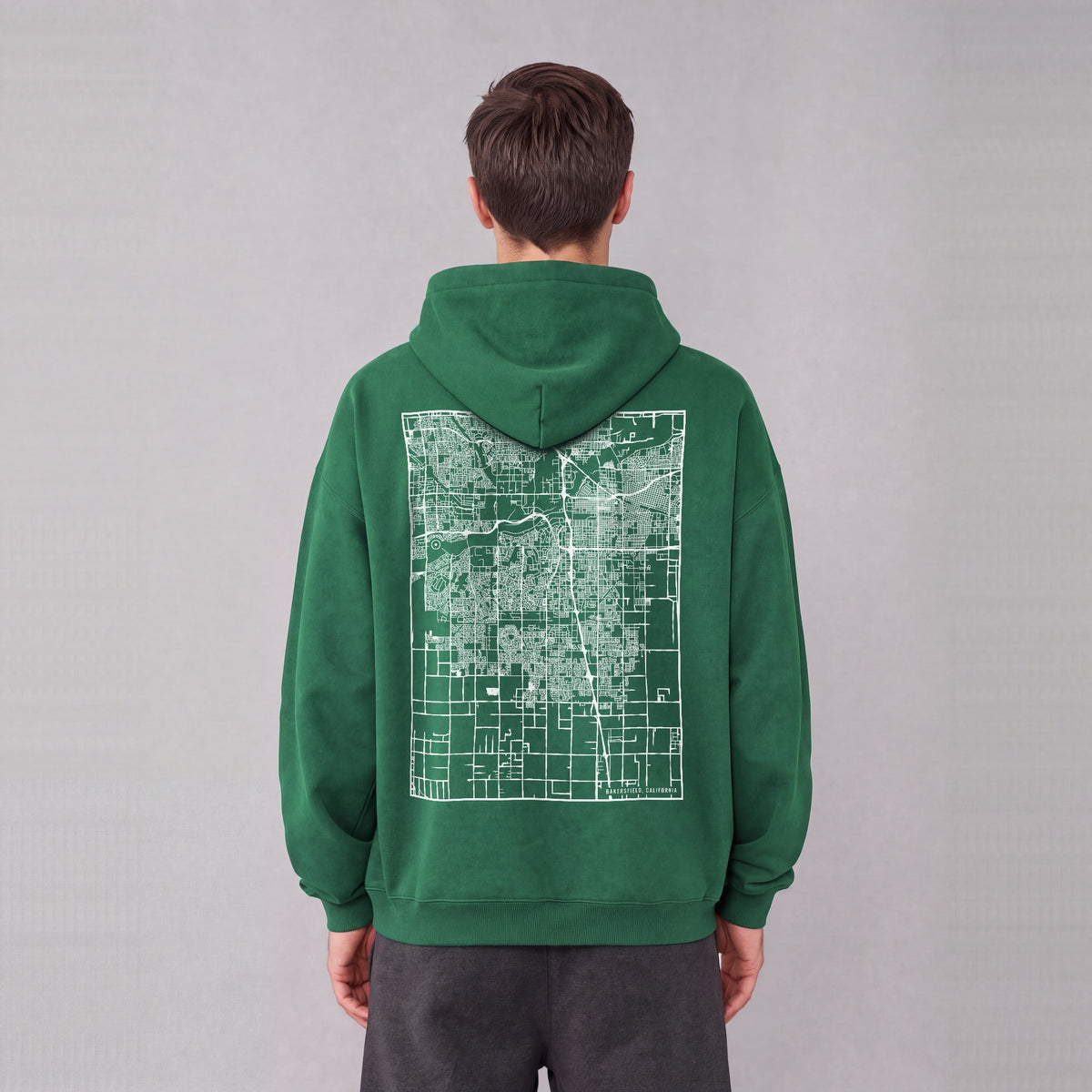 Bakersfield map hoodie, back print on model - Eden Green