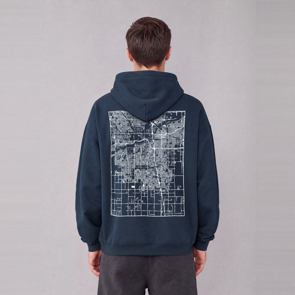 Bakersfield map hoodie, back print on model - Navy Blue