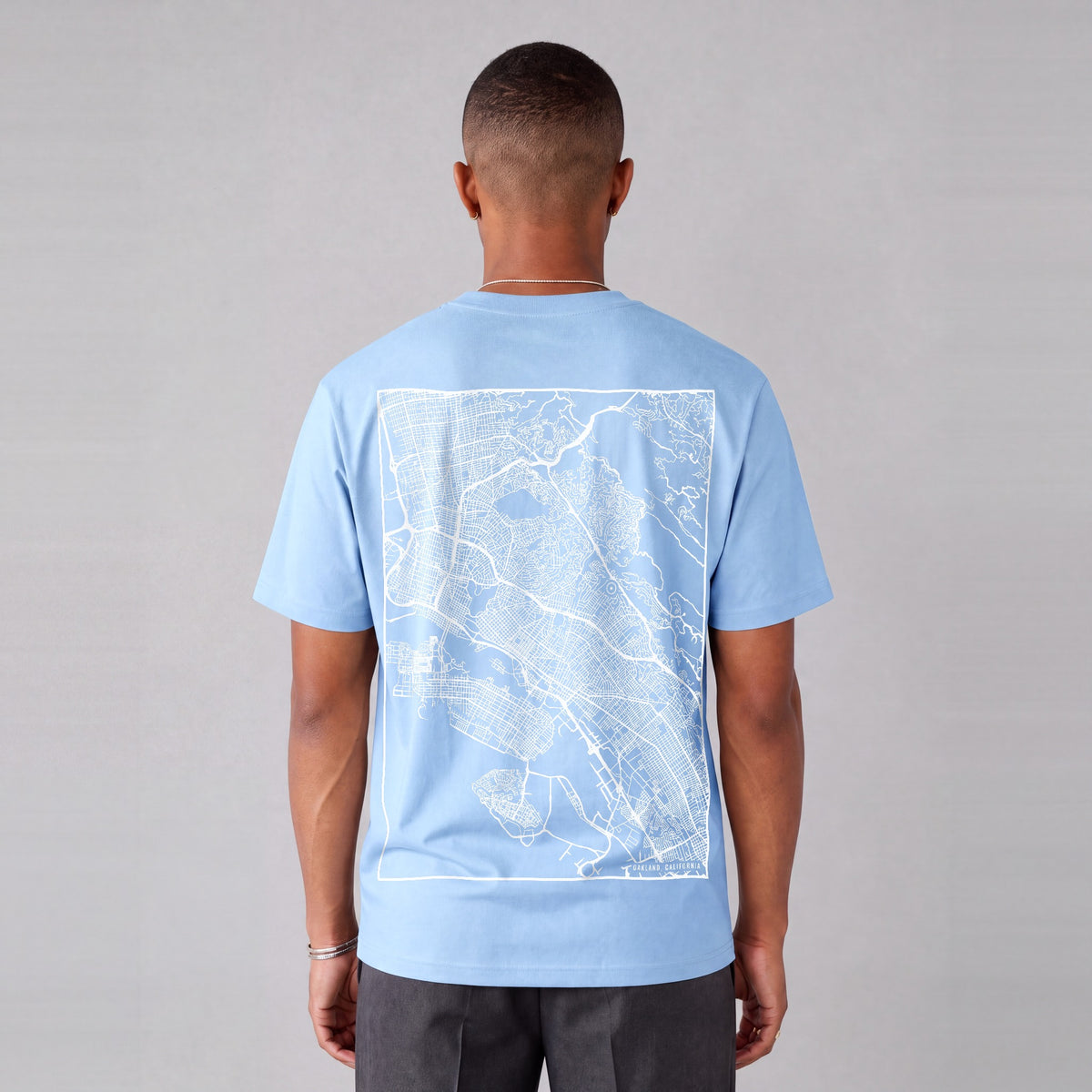 Oakland map tee, back print on model - Light Blue