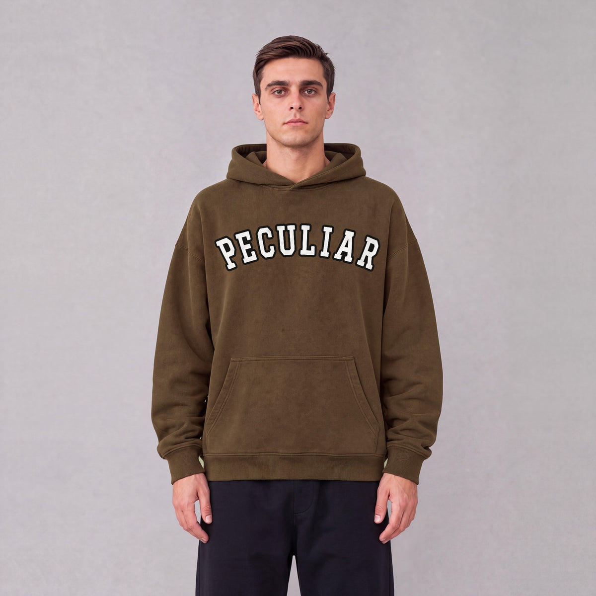 "Peculiar" collegiate hoodie front print on model - Coffee