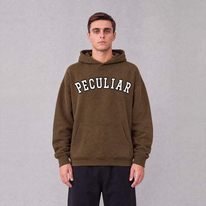 "Peculiar" collegiate hoodie front print on model - Coffee