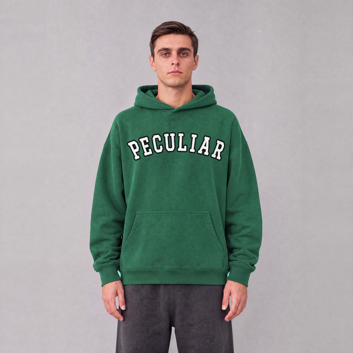 "Peculiar" collegiate hoodie front print on model - Eden Green