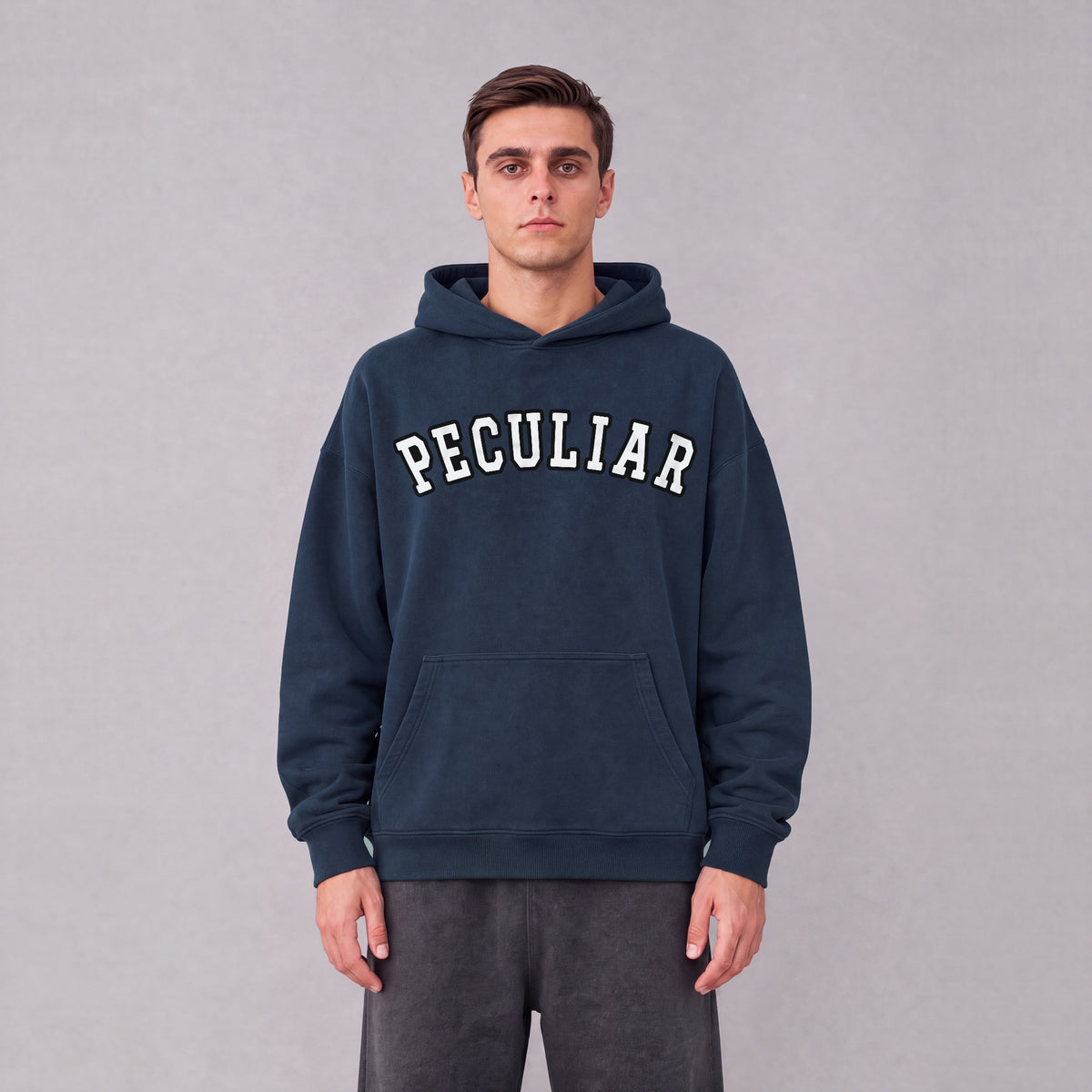 "Peculiar" collegiate hoodie front print on model - Navy Blue