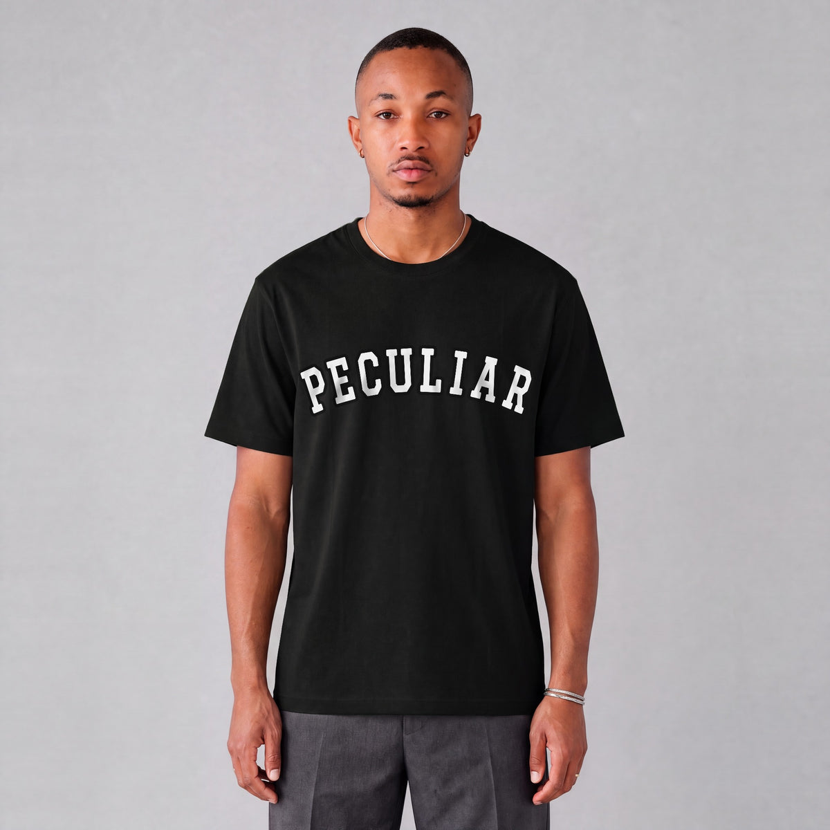 "Peculiar" collegiate tee front print on model - Black