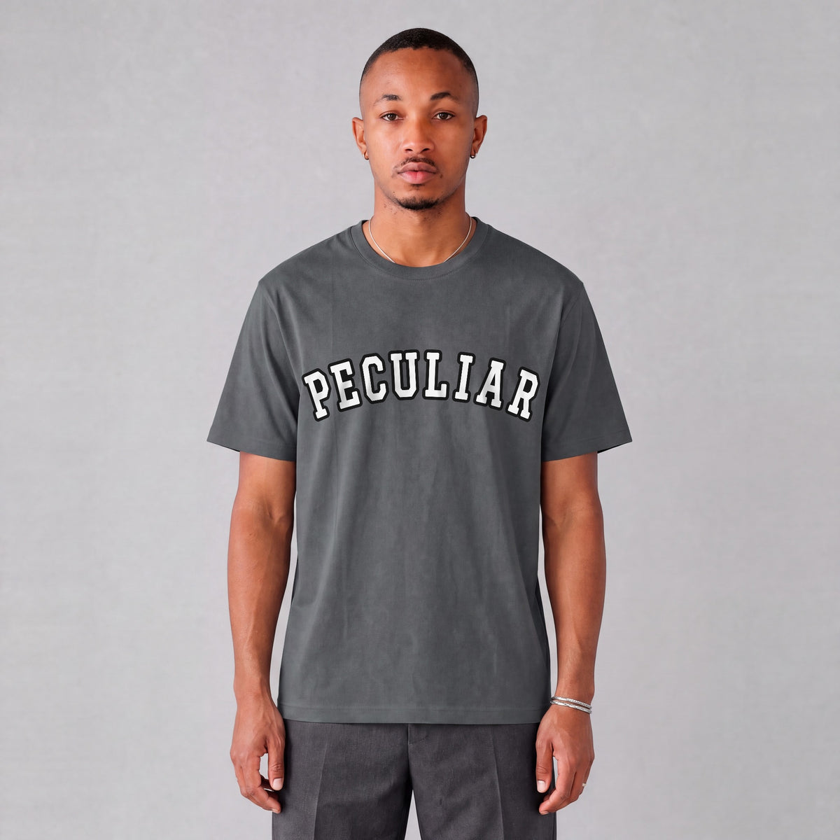 "Peculiar" collegiate tee front print on model - Charcoal