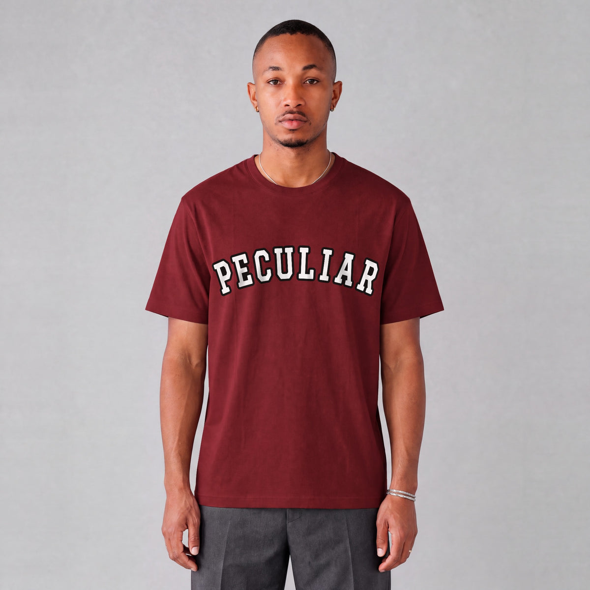 "Peculiar" collegiate tee front print on model - Maroon