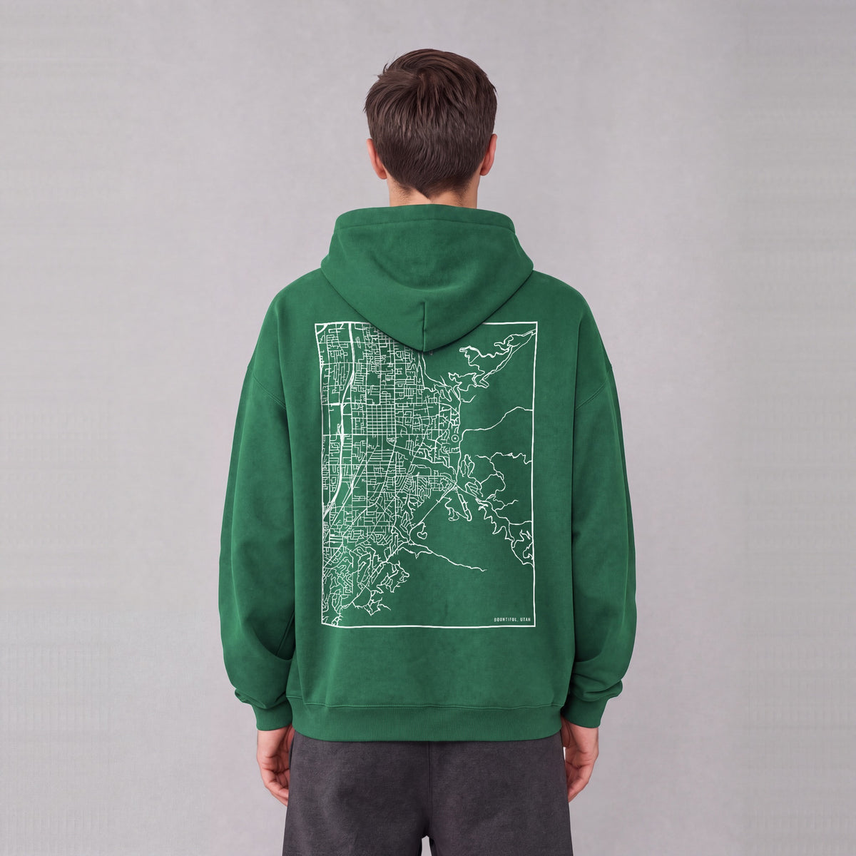 Bountiful map hoodie, back print on model - Eden Green
