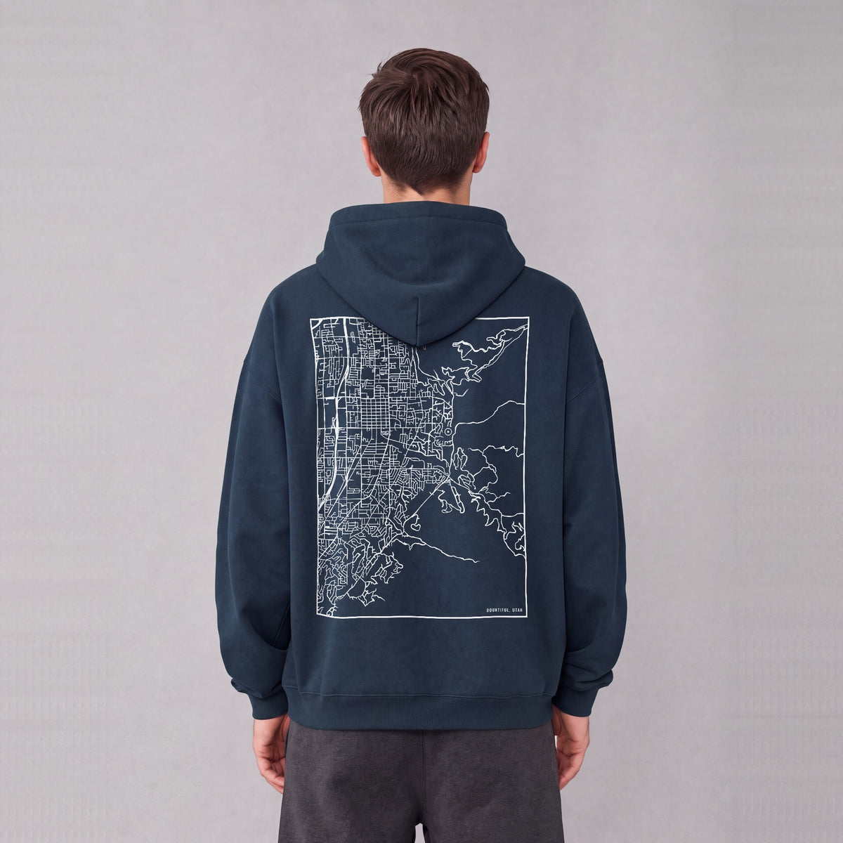 Bountiful map hoodie, back print on model - Navy Blue