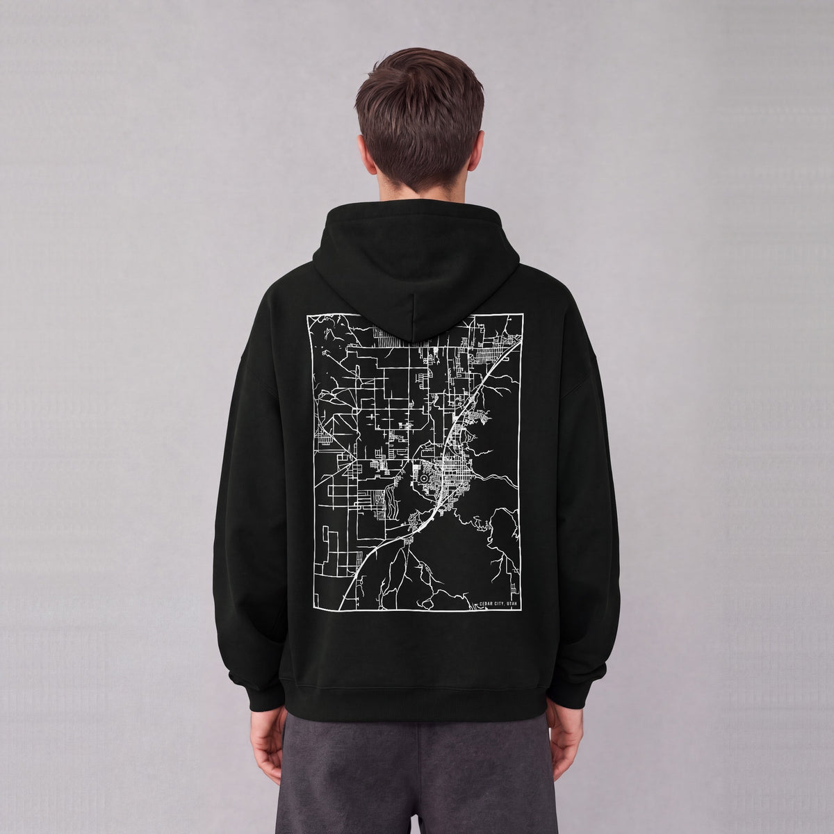 Cedar City map hoodie, back print on model - Black