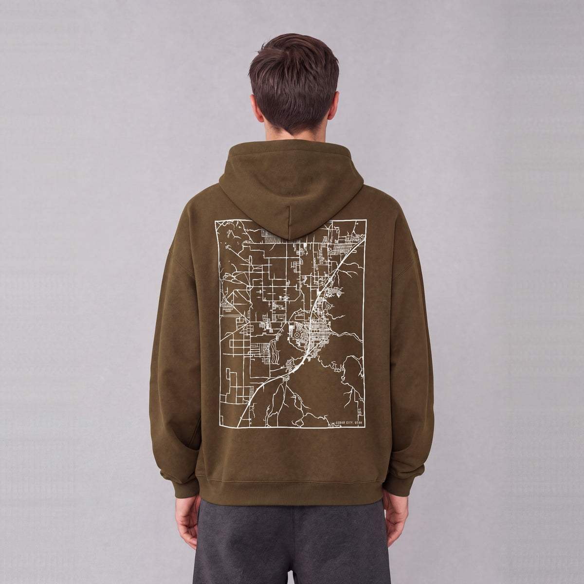 Cedar City map hoodie, back print on model - Coffee