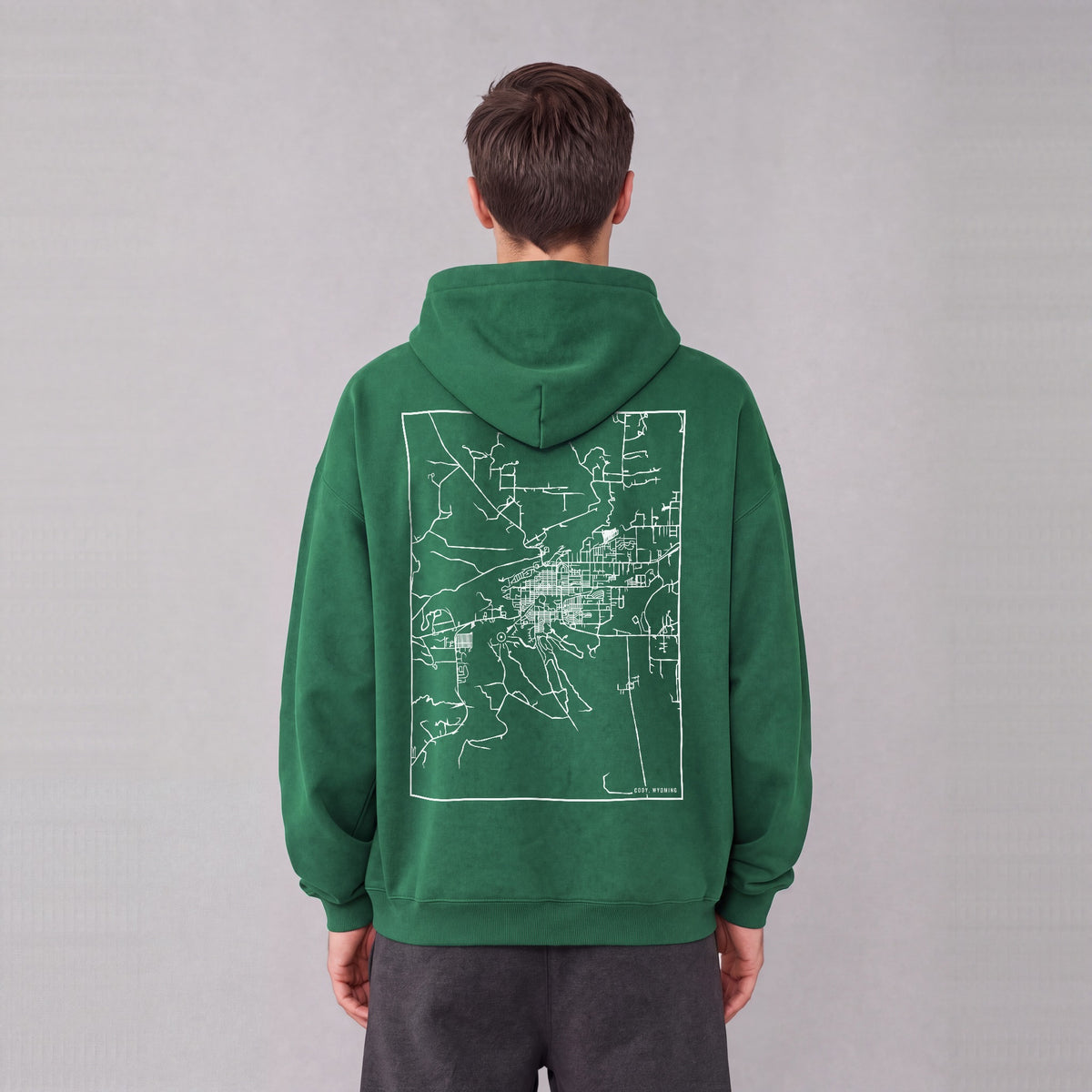 Cody map hoodie, back print on model - Eden Green