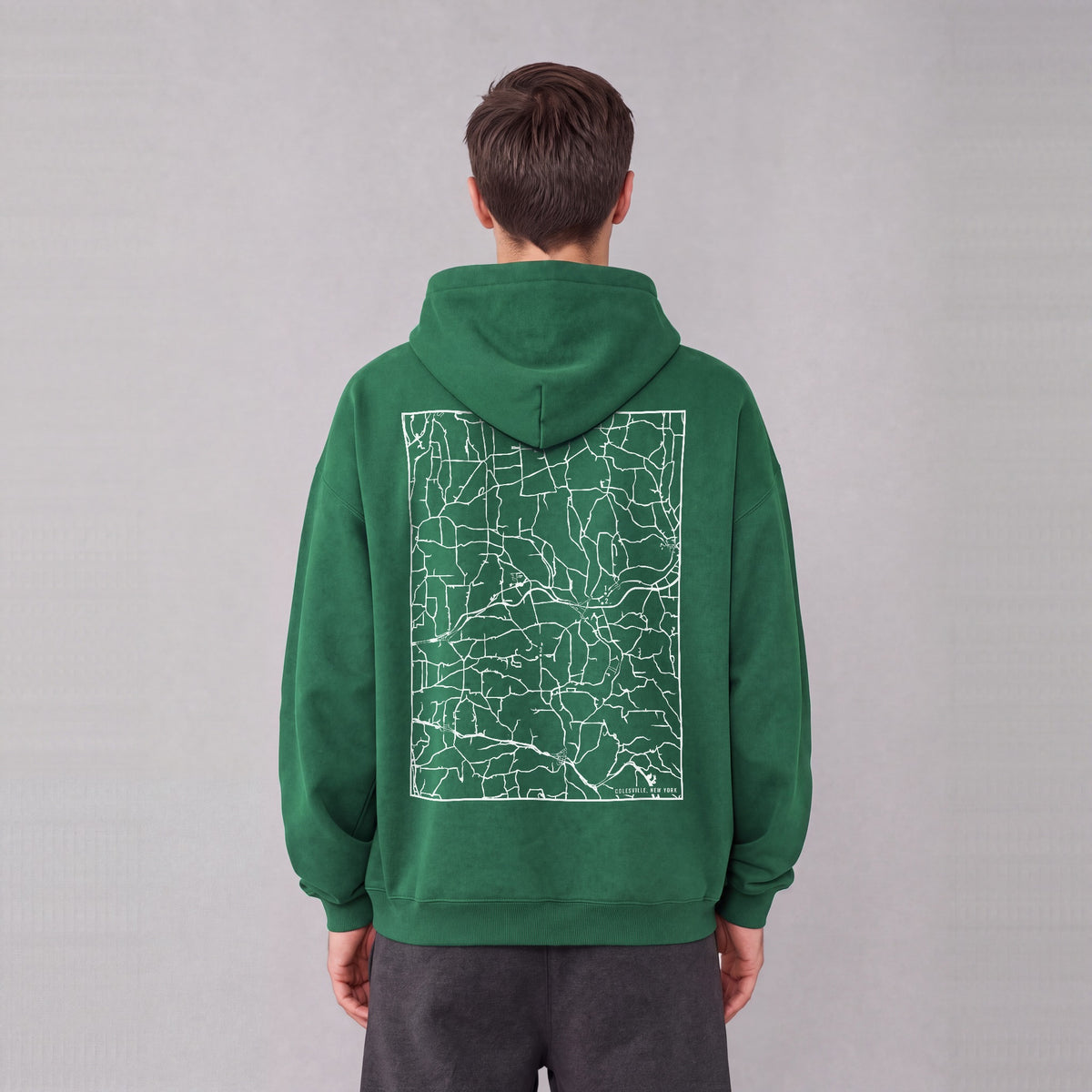 Colesville map hoodie, back print on model - Eden Green