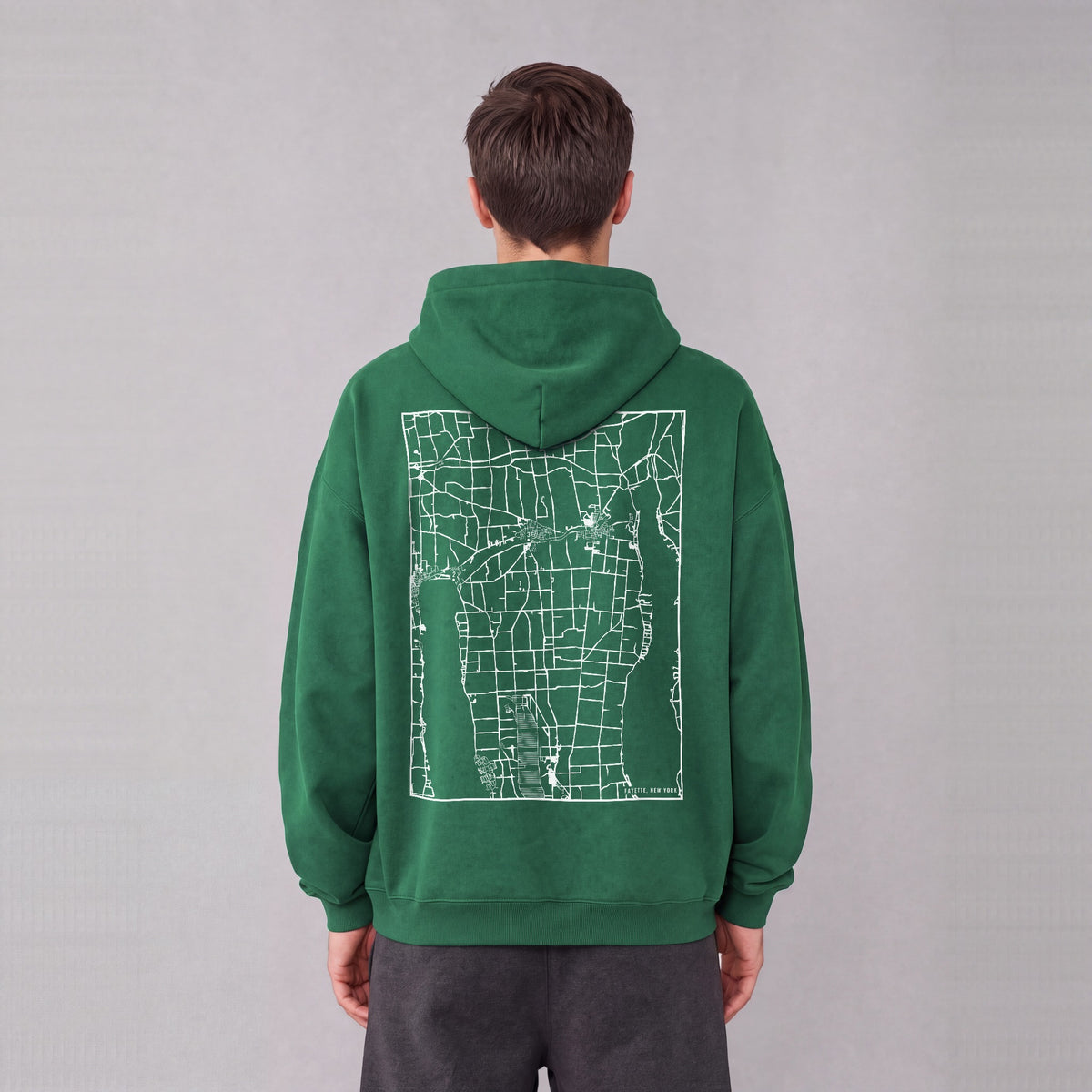 Fayette map hoodie, back print on model - Eden Green