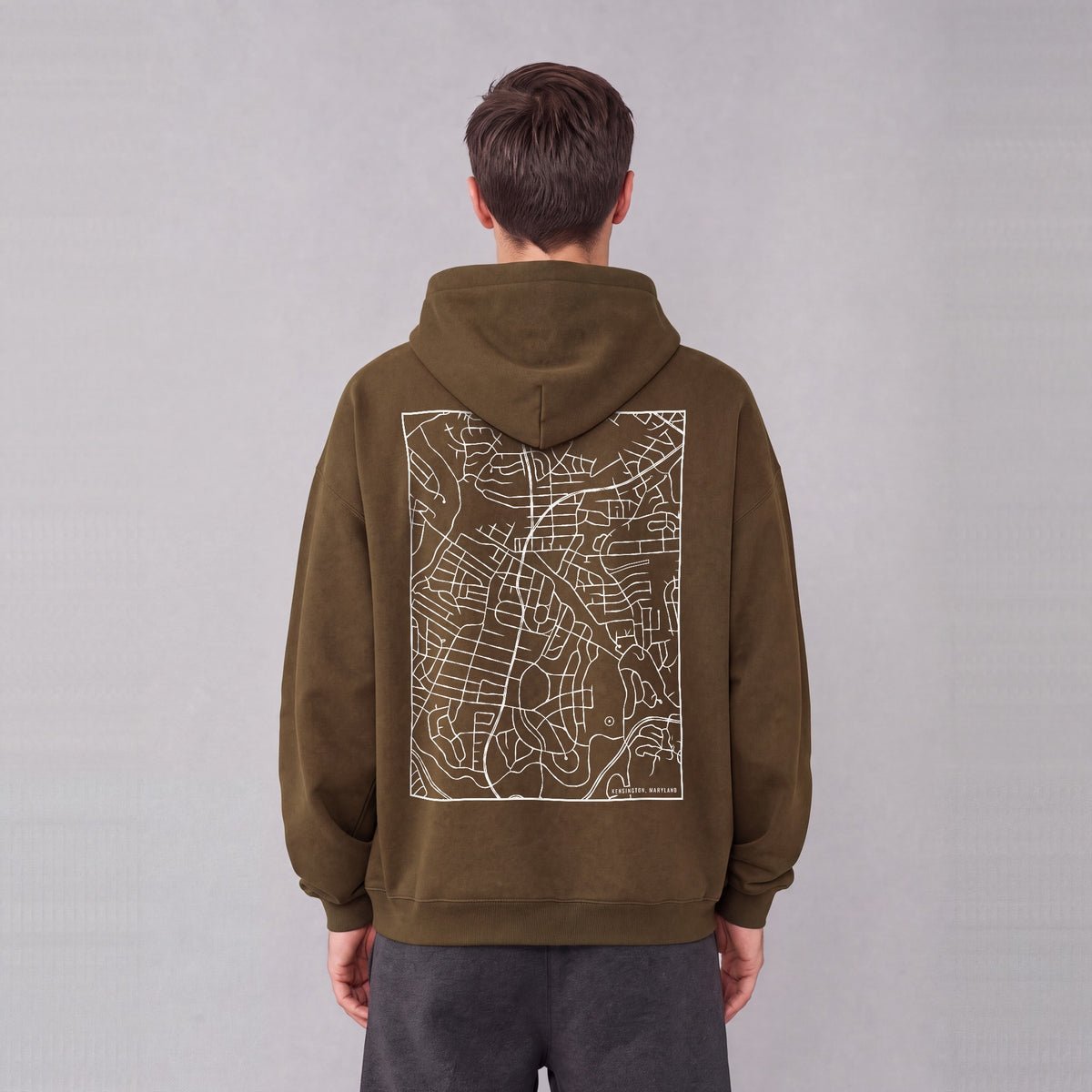 Kensington map hoodie, back print on model - Coffee