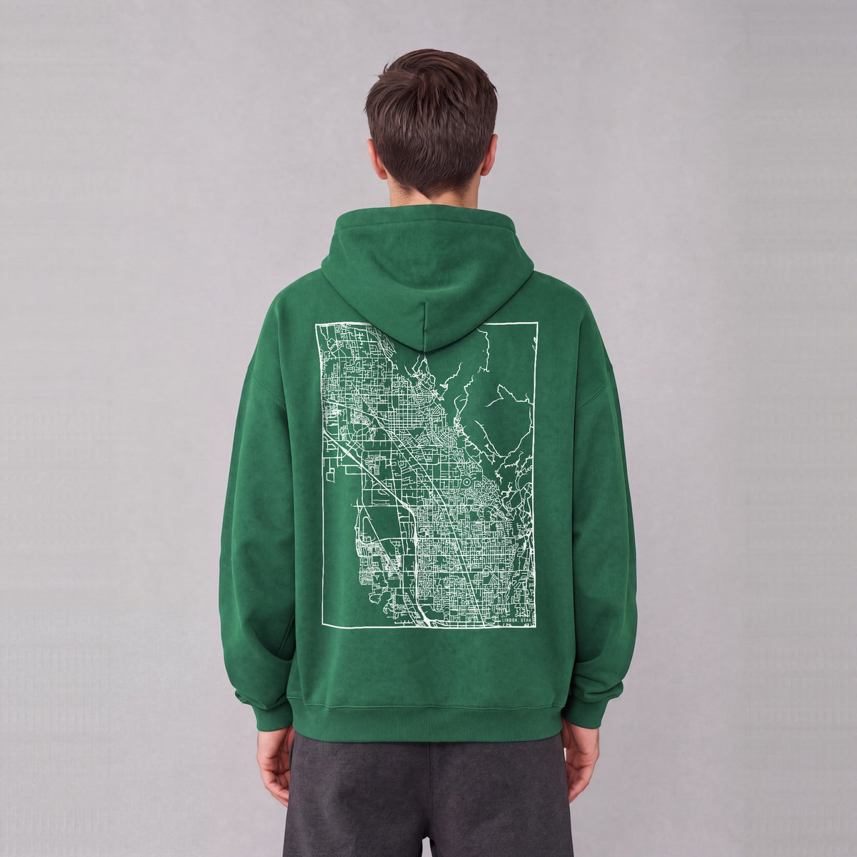 Lindon map hoodie, back print on model - Eden Green