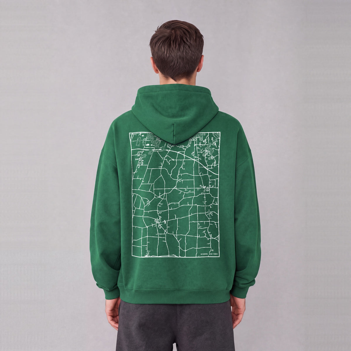 Mendon map hoodie, back print on model - Eden Green