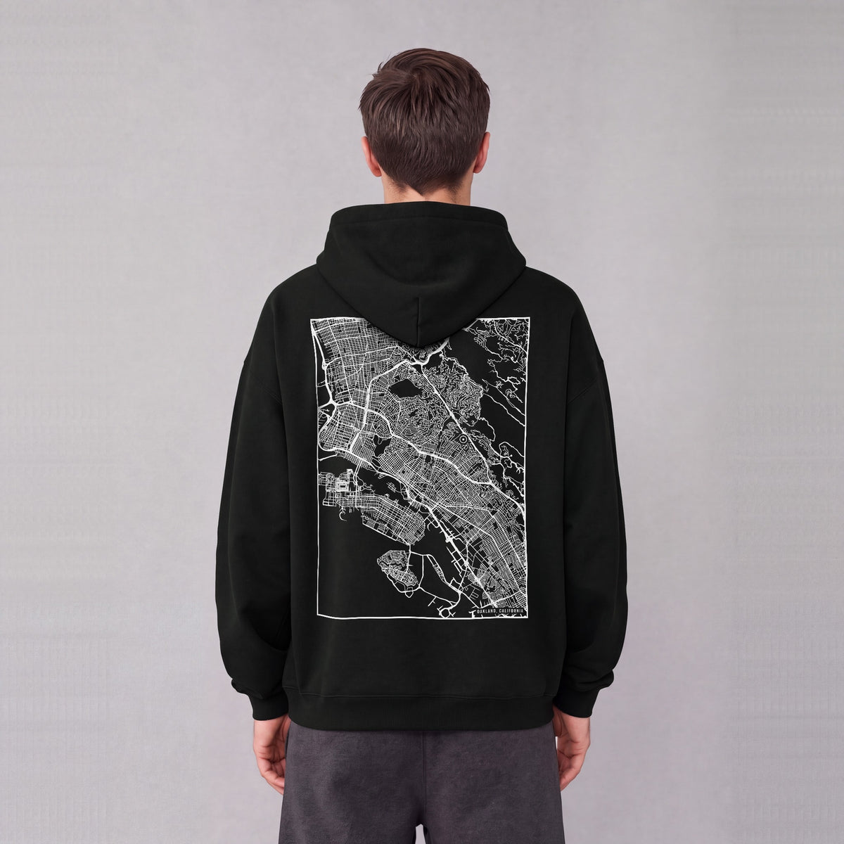 Oakland map hoodie, back print on model - Black