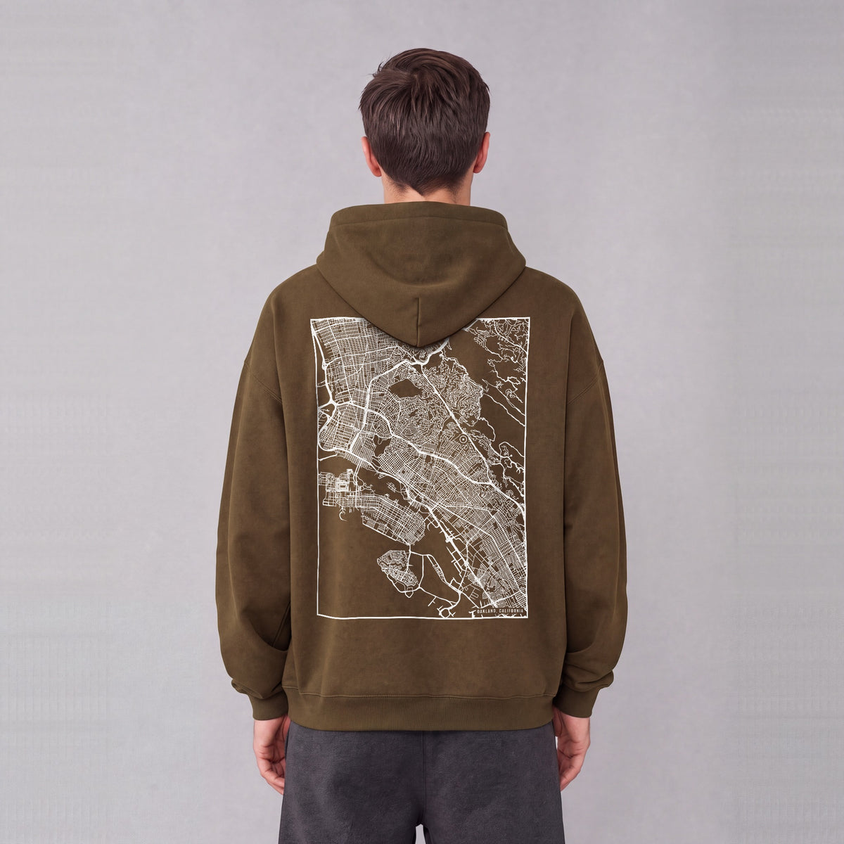 Oakland map hoodie, back print on model - Coffee
