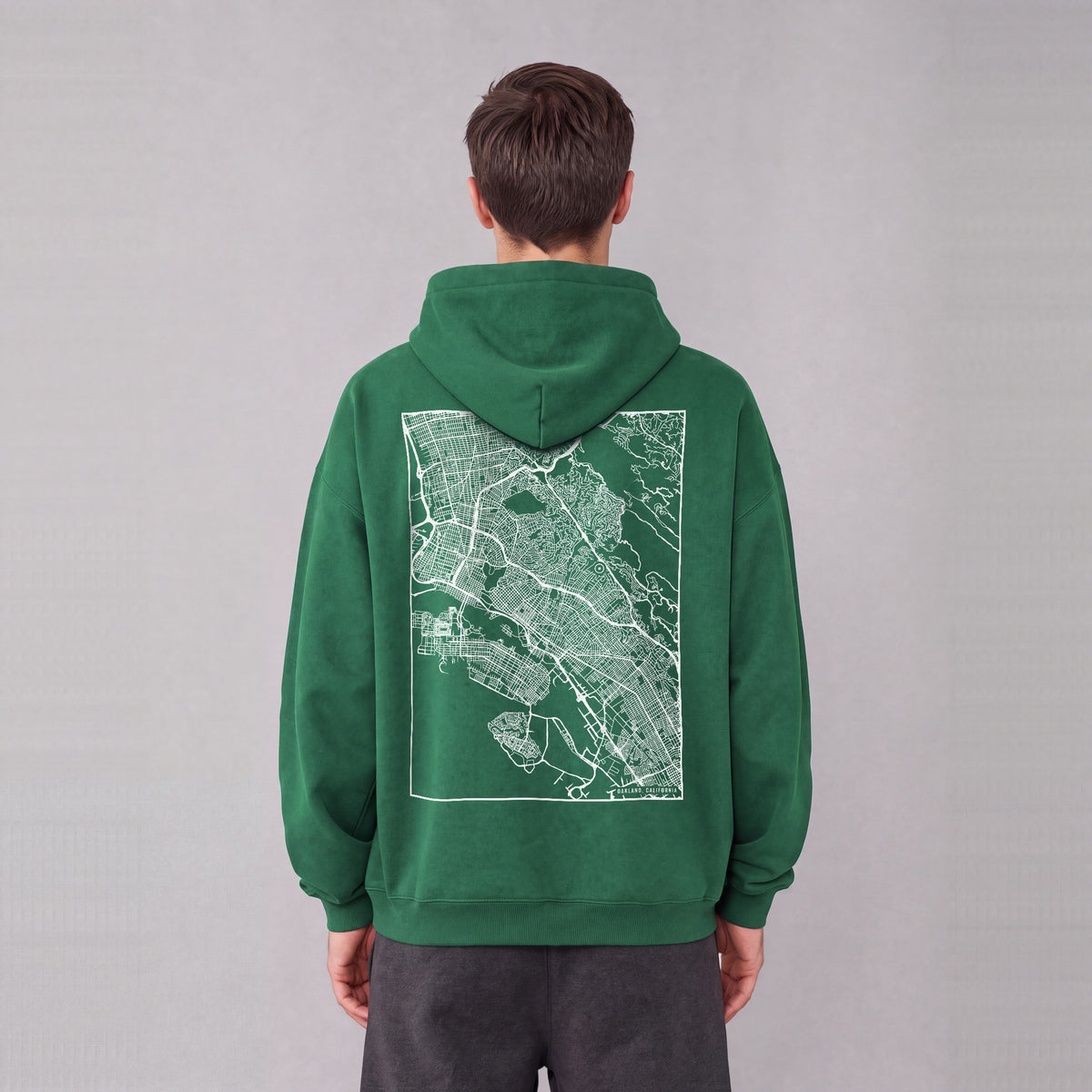 Oakland map hoodie, back print on model - Eden Green