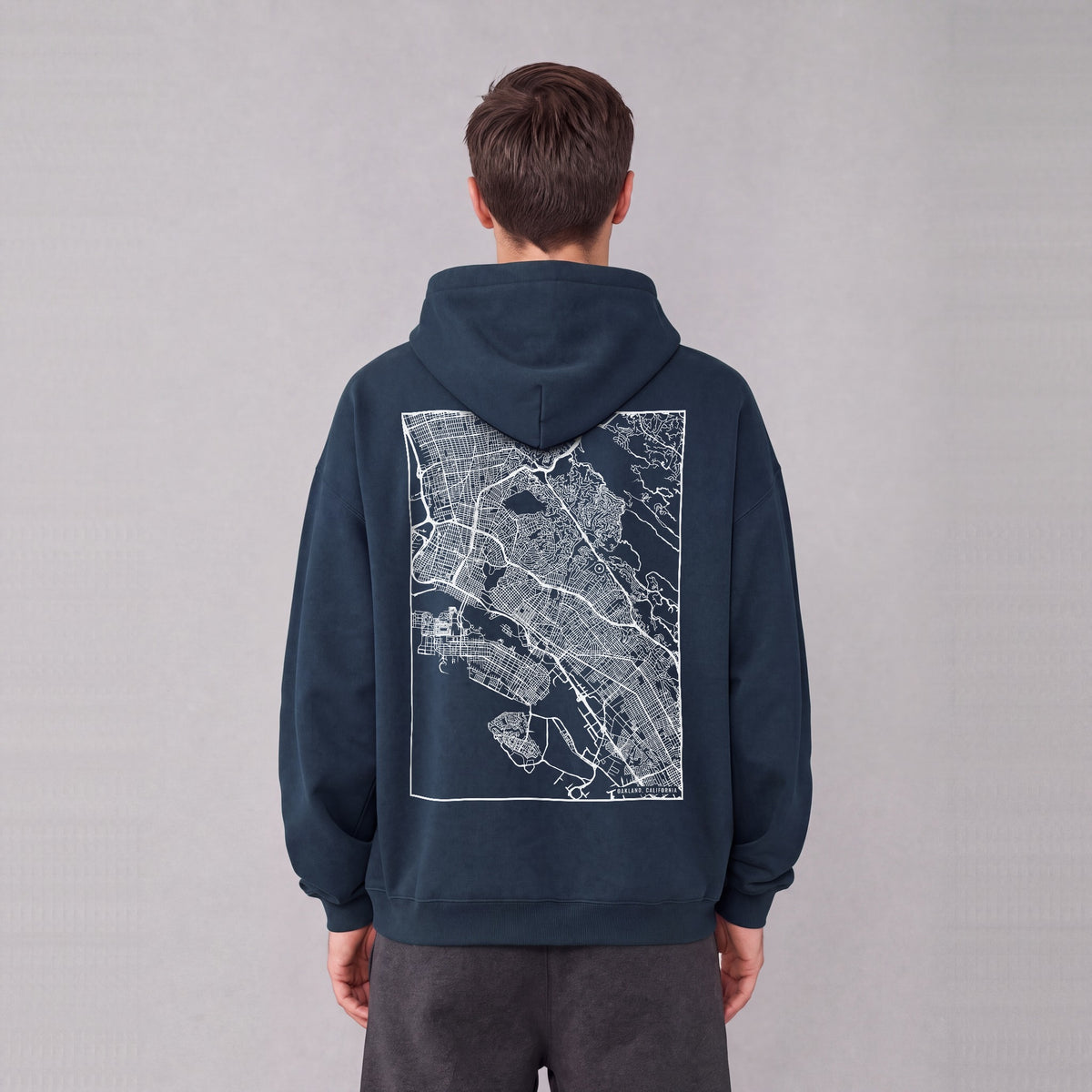 Oakland map hoodie, back print on model - Navy Blue
