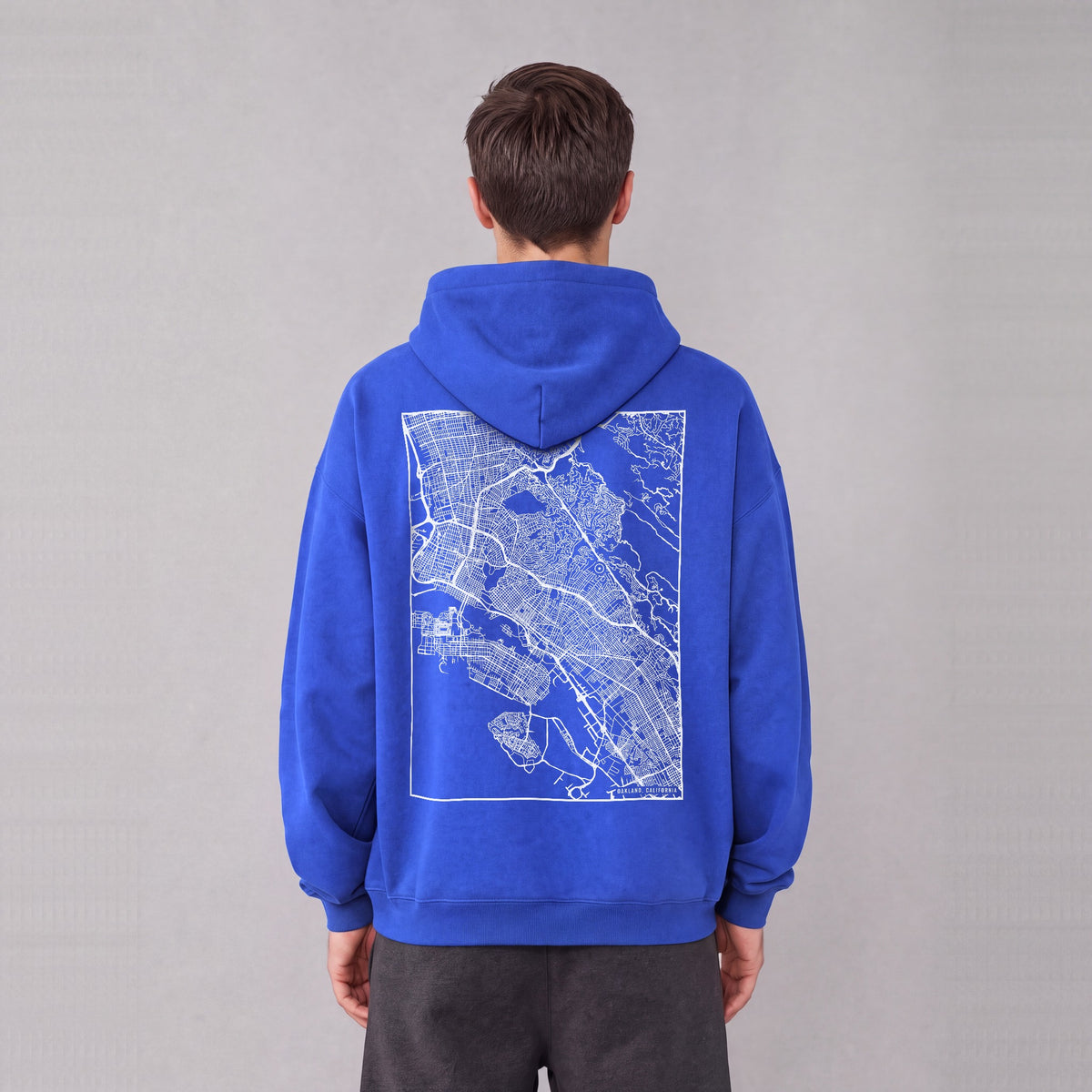Oakland map hoodie, back print on model - Royal Blue