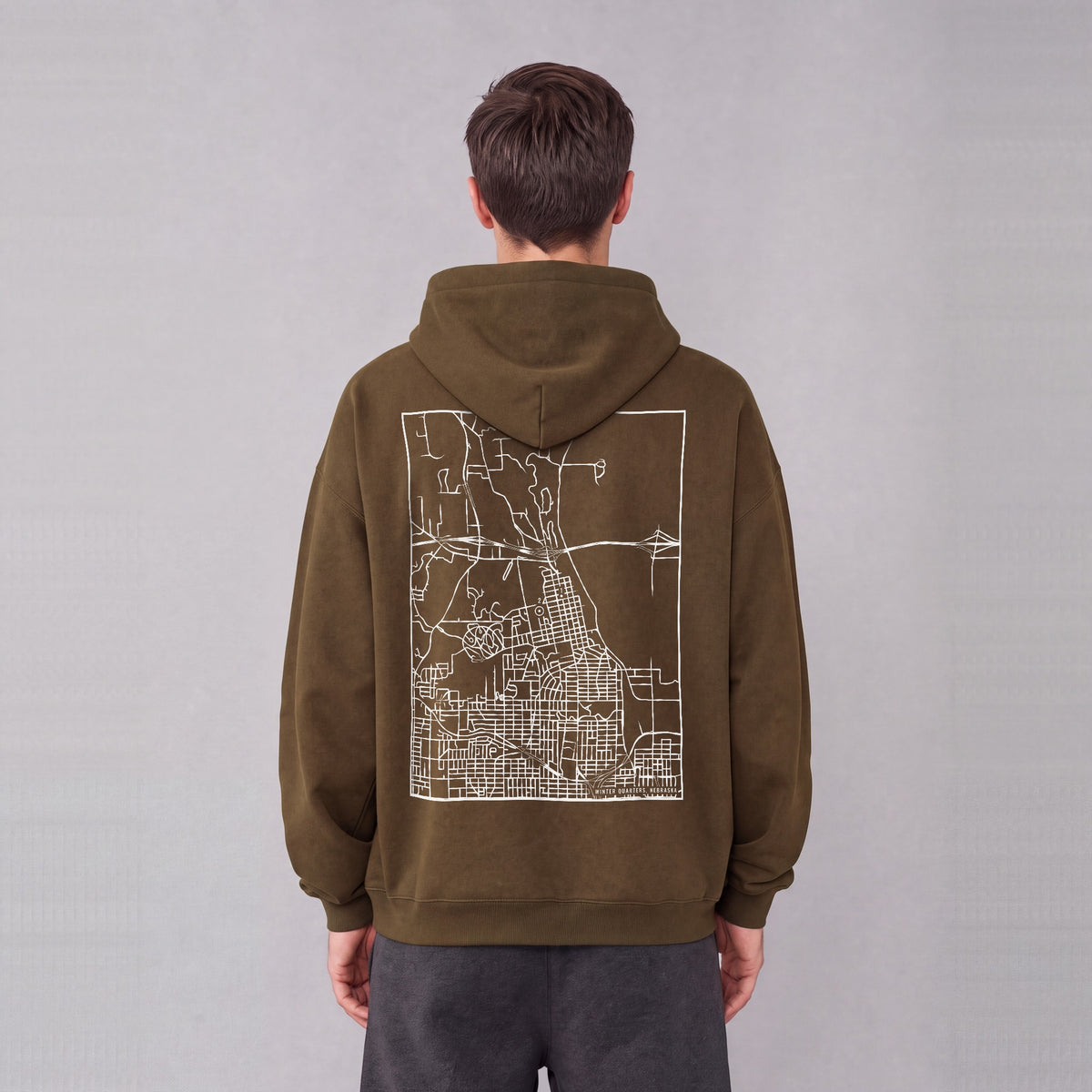 Winter Quarters map hoodie, back print on model - Coffee