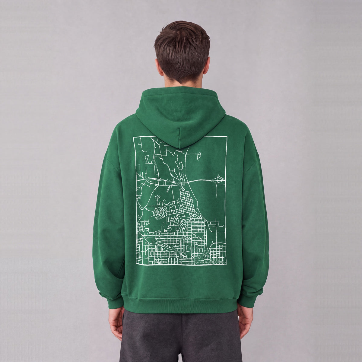 Winter Quarters map hoodie, back print on model - Eden Green