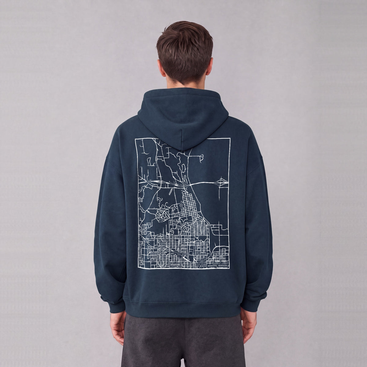 Winter Quarters map hoodie, back print on model - Navy Blue